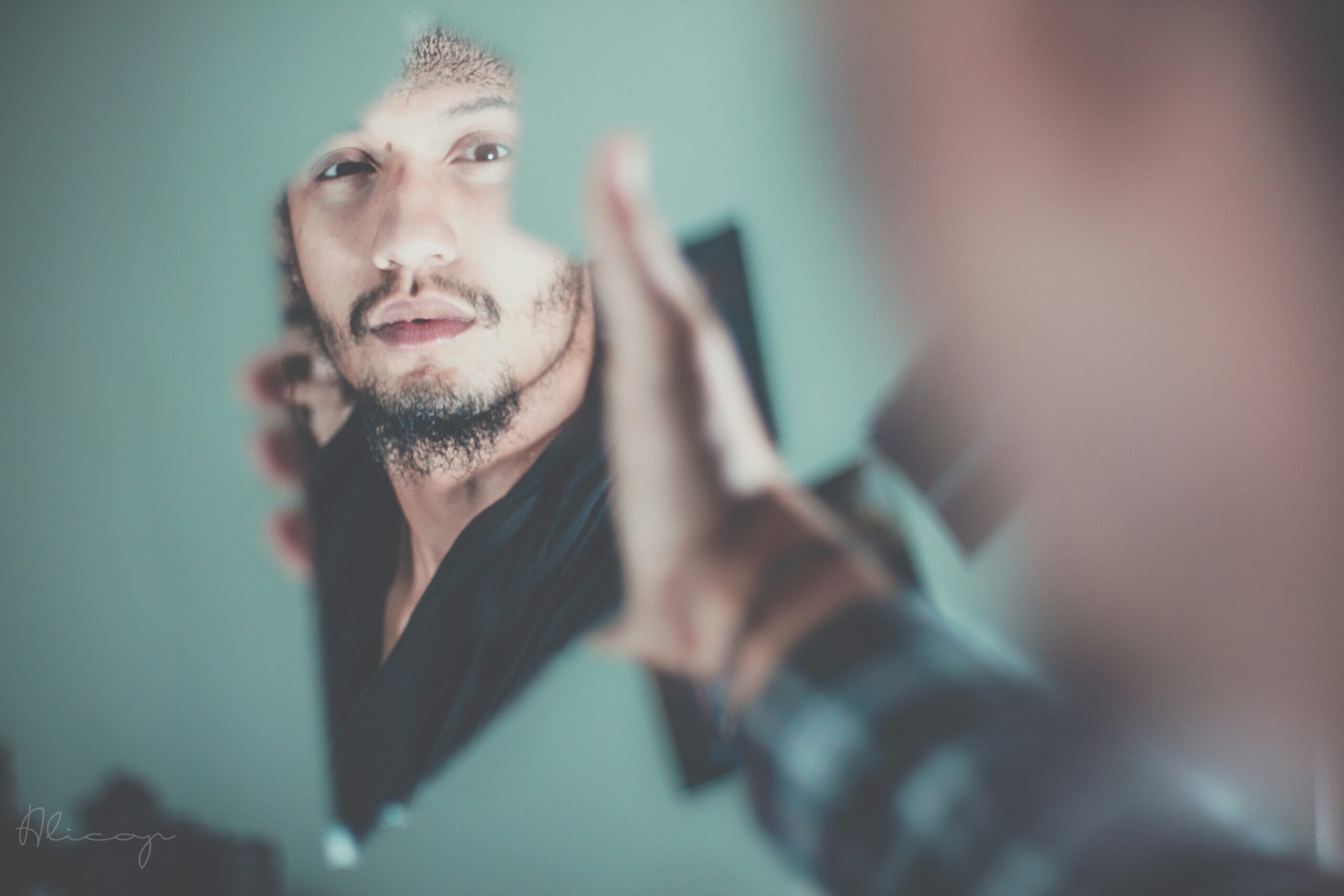 Man looking at himself in mirror fragment