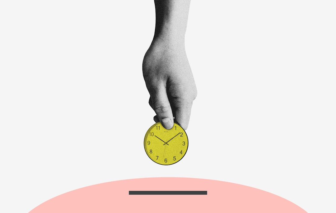 Hand dropping a coin, in the form of a clock face, into a piggy bank